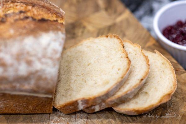 Fresh cut bread at home with their raspberry jam.