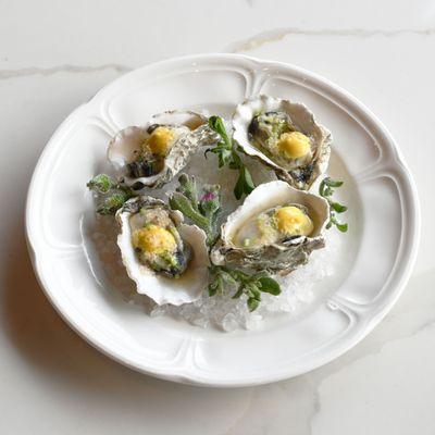 Poached oysters with ginger dashi, lemongrass, curry aioli, finger limes