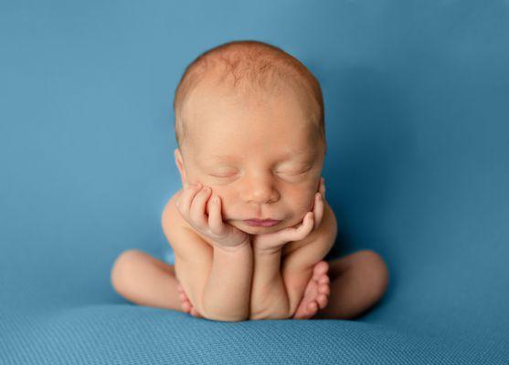 Froggy pose during newborn photography session.