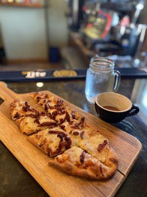 Cheese flat bread, add sun dried tomatoes, and double espresso.