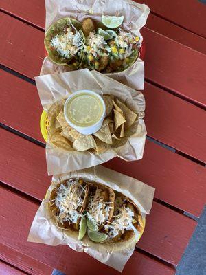 Fish tacos with cabbage and mango salsa, smoked cheddar and cilantro tomatillo, side of chips and cheese sauce.