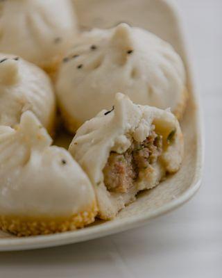 Classic Sheng Jian Bao, featuring a soft puffy steamed top and a crispy golden pan-fried bottom and a fresh meatball filling!