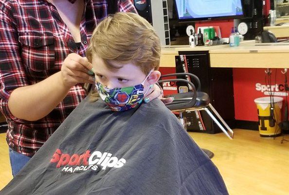 My kid getting hair cut at Sports Cuts.