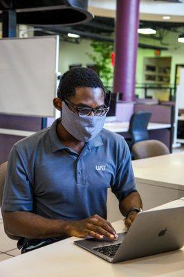 Assistant Director of Admissions Mr. Walker working in the UAT Commons