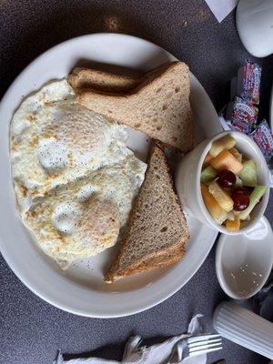 Two eggs over easy - additional charge for cup of fruit.