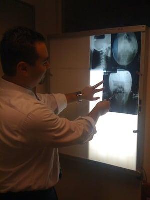 Dr. Elkins reviews my x-rays.  See my military neck in the upper left-hand corner (gnarly!).