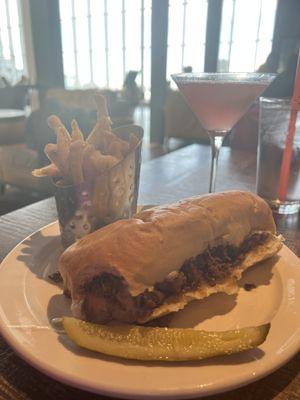 Cheesesteak, fries, and a cosmo