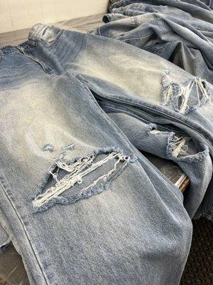 Distressed & grinding on denim jeans