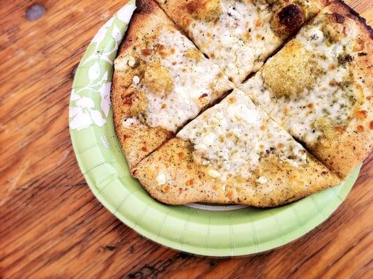 Basil Pesto Pizza with Mozzarella & Feta Cheese from their wood-fired Pizza oven.