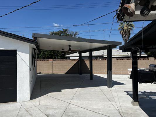 Roof mounted 
Slate color patio cover with white ceiling panels and fan