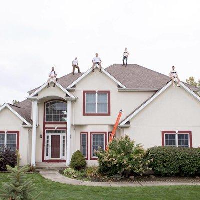 The crew on top of a Beautiful Home