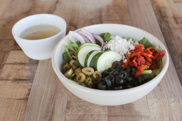 Vibrant and tasty Greek salad filled to the rim for a refreshing meal all it's own.