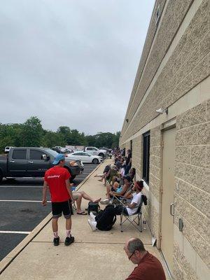 The line wraps around the building once and then down the highway.