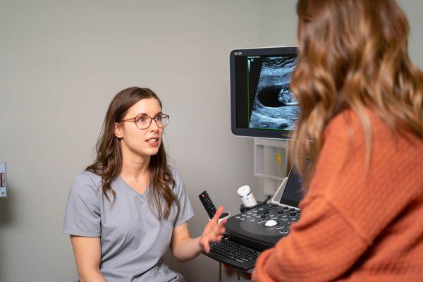 A nurse explaining ultrasound results to patient