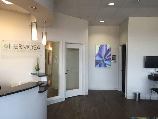 Front desk and entrance at Dallas dentist Hermosa Dental & Orthodontics