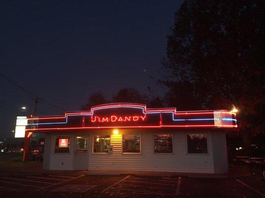 The sign all lit up at night