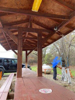 Eating area with bottle openers on the posts; hand washing station on the right.