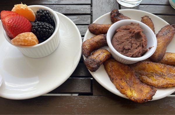 Fresh fruit: strawberries, oranges, blackberries, and blueberries. Fried Plantain with refried beans.