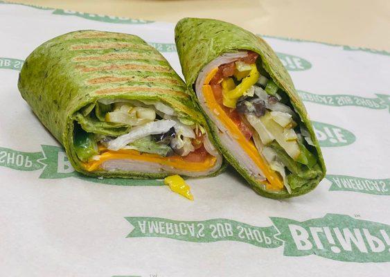 Spinach wraps stuffed with turkey, cheese, and all the veggies you could dream of!