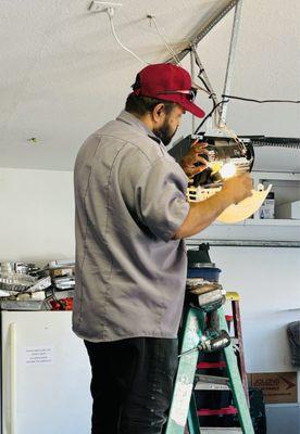 Javier Torres repairing my  large garage door opener.