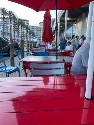 Outside the restaurant there are a bunch of tables you can sit at to wait, they don't serve food out here.