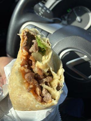 Inside a carne asada regular burrito: very little meat, rice, beans and grilled vegetables