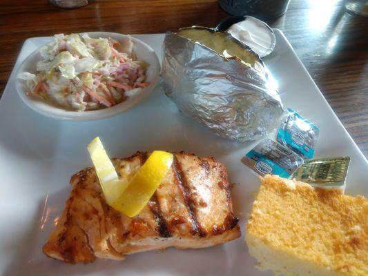 Smoked salmon with baked potato, cornbread and cole slaw.