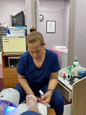 Jazmin doing clients nails. She has an eye for details!