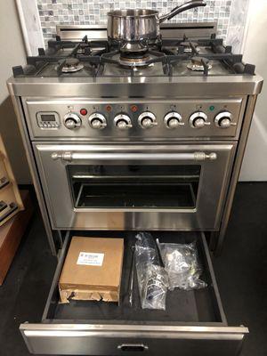 Rotisserie parts and WOK burner included in warming drawer.