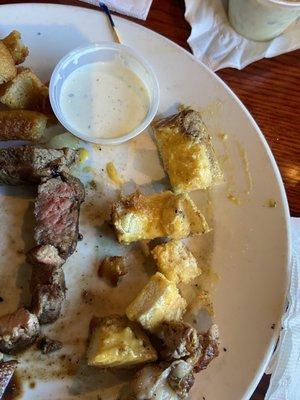 steak bites and garlic bread.