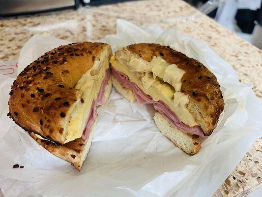 Egg, ham, and cheese bagel sandwich on an onion bagel.