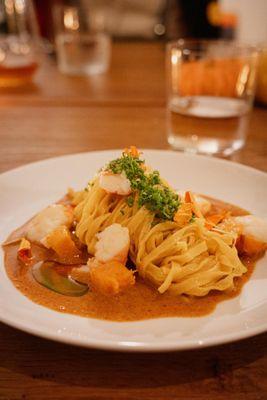 Hand-made butternut squash pasta with seafood laksa sauce