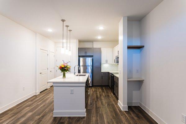 A2 floor plan with expansive island and media nook with open shelving.