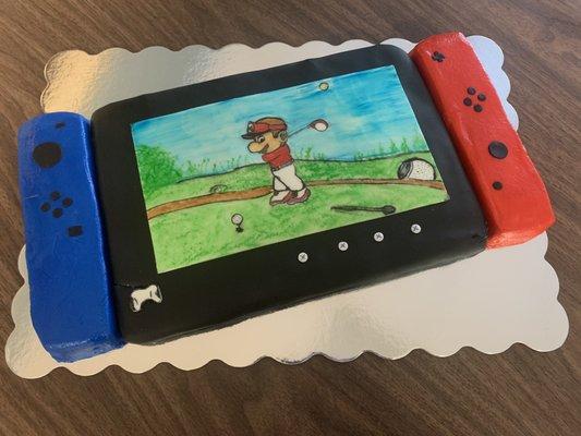 Nintendo Switch themed birthday cake with hand painted game screen.