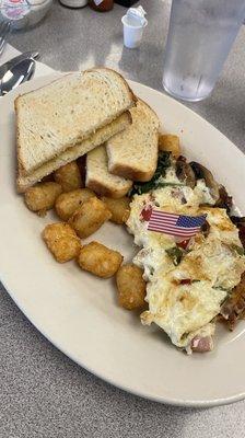 Egg white veggie omelet with sourdough toast and tater tots