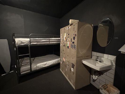 private room with bunks and a sink