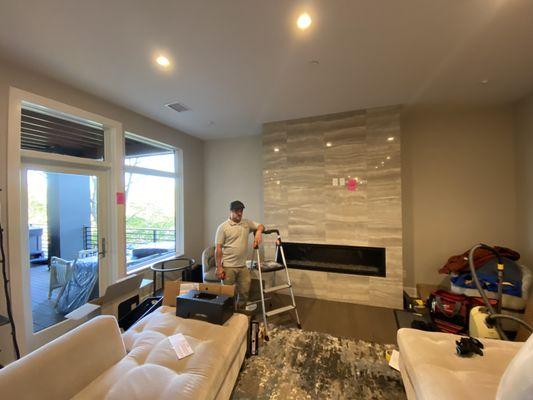 Before: New construction condo Ann Arbor, third floor. Marble fireplace. What size TV do you think belongs here?