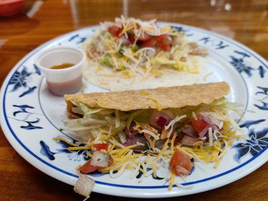 Ground beef taco with a crisp shell and a shredded chicken taco with a soft tortilla