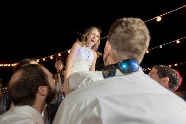 Lots of fun as this Bride is hoisted up on a chair during The Hora at The White Room