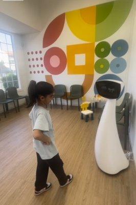 My daughter playing with Robin the robot