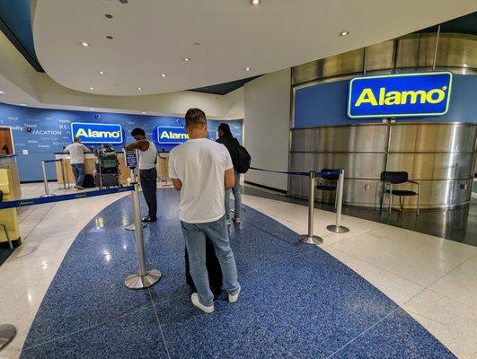 Alamo Rent a Car inside the IAH Houston Rental Car Center. I scanned the QR code and skipped this line.