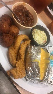 Catfish filets, hush puppies, baked beans, slaw, and baked potato