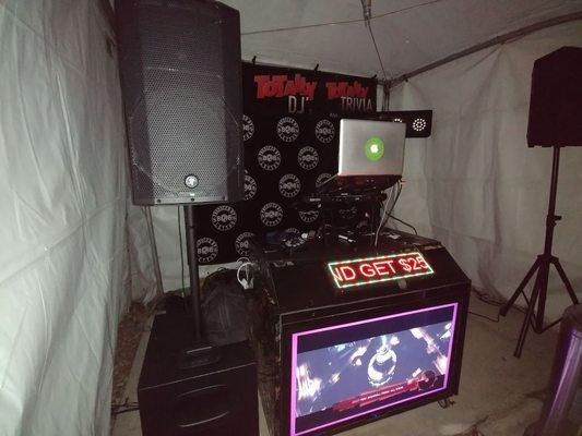 DJ Setup with Banner & Lighting.