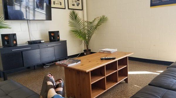 Relaxing on a comfy couch in an air conditioned waiting room.