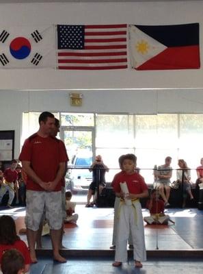 Alex thanking his instructors with advanced yellow belt