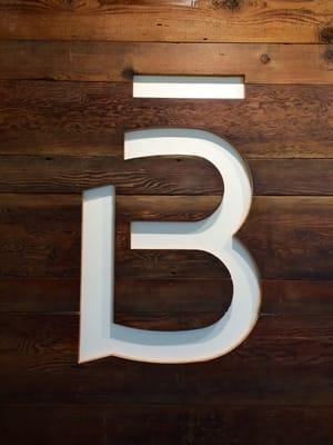 I love this Barre3 logo made with reclaimed wood.