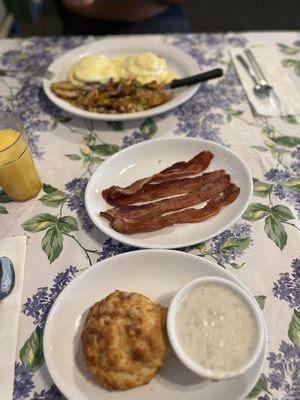 Biscuit with gravy, bacon and eggs bene plate