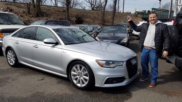 Happy client picking up his new Audi.