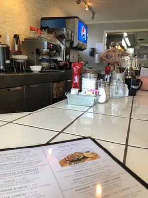 Sitting at the meticulously clean counter for breakfast.