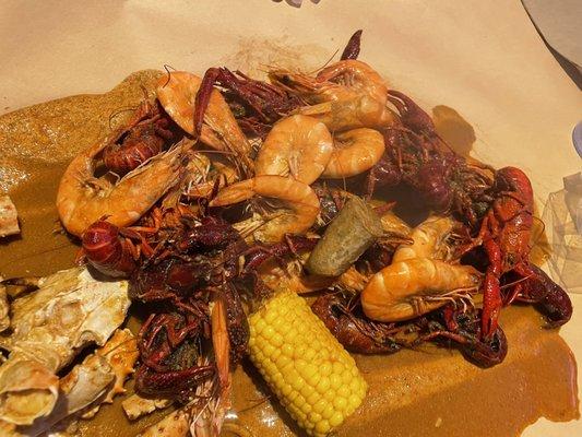 Mix of shrimp, crawfish, sausage, and corn in the Cajun sauce, 3 stars. Flavors out of this world amazing. Would recommend!